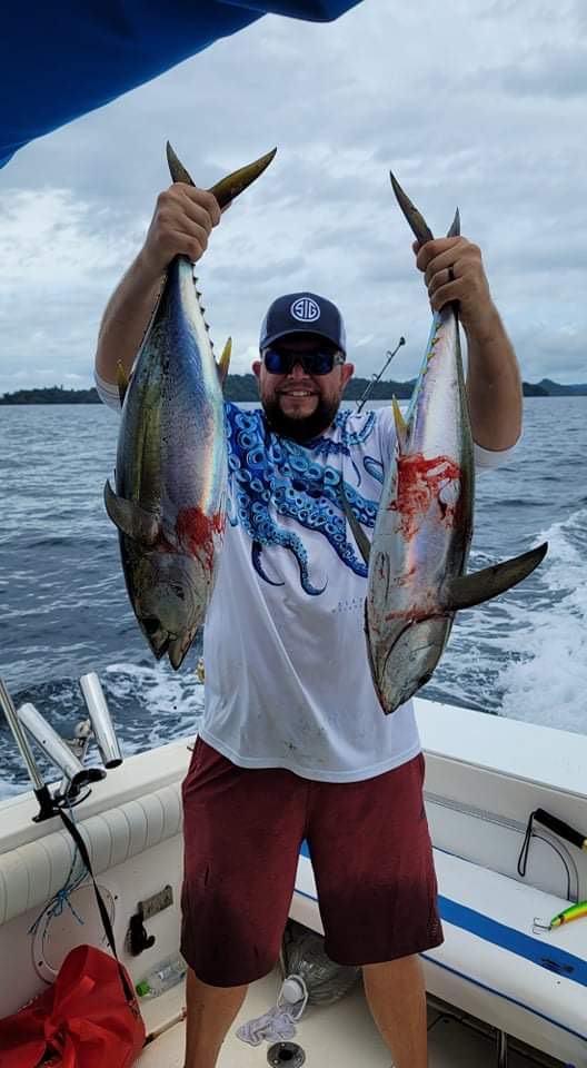Mark Gabrielli holding two tuna, one in each hand